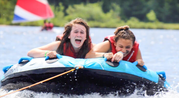 Campers tubing on lake