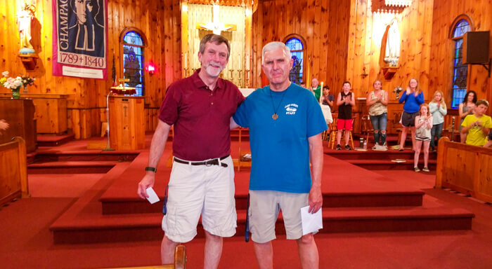 Two Camp Marist staff members inside of church