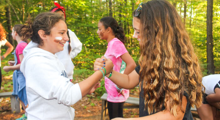 Girls shake hands at summer camp