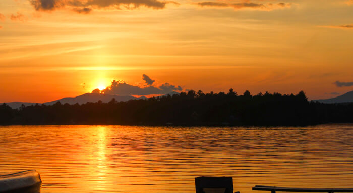 Orange sunset over camp lake