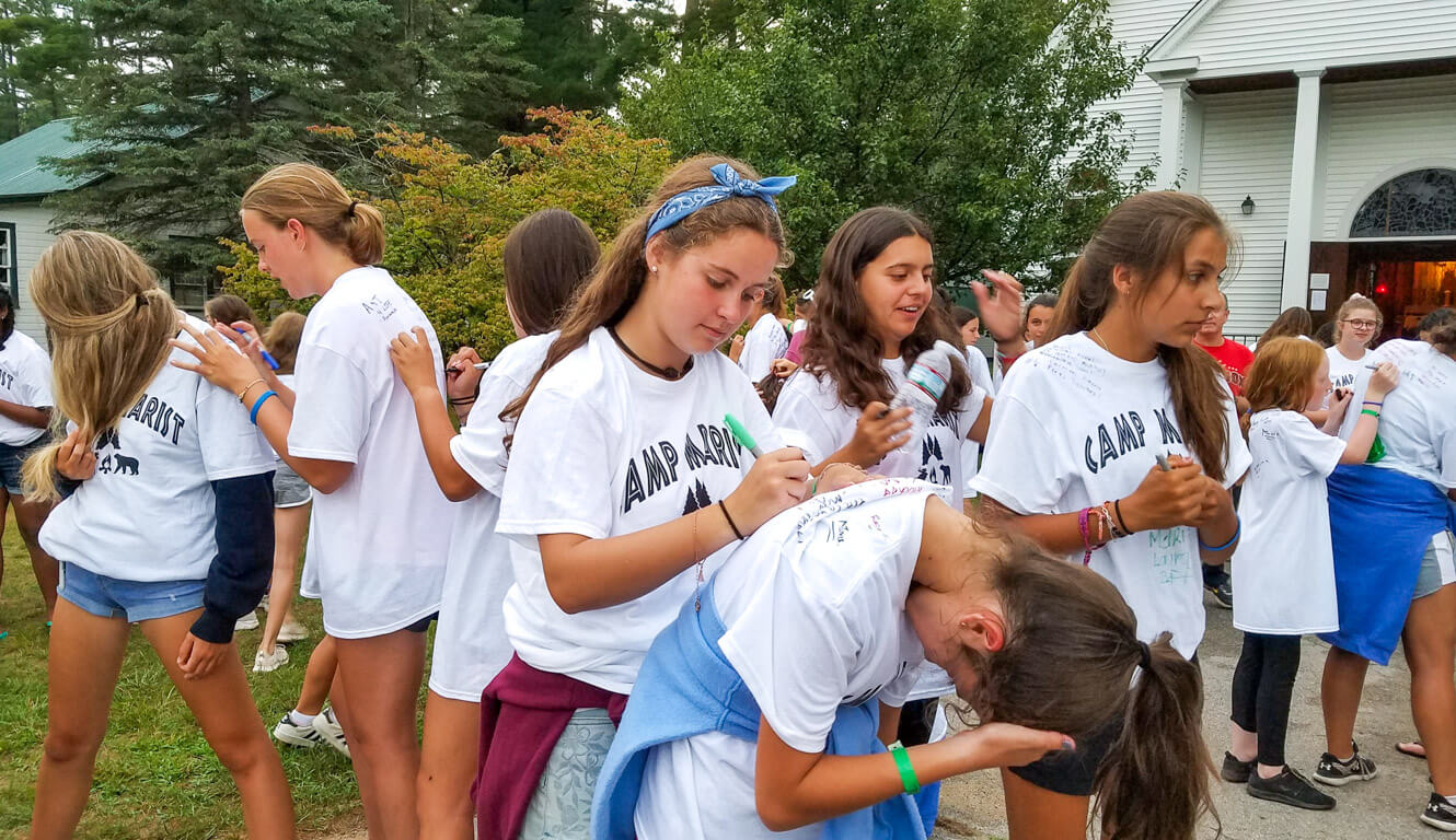 Marist campers sign each others' shirts