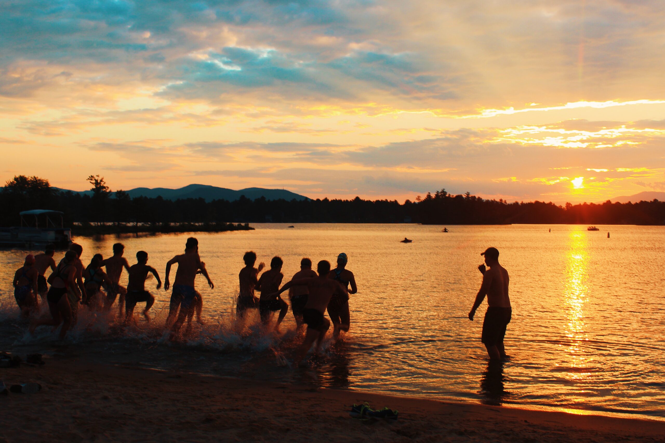 Group of campers hold up Camp Marist banner